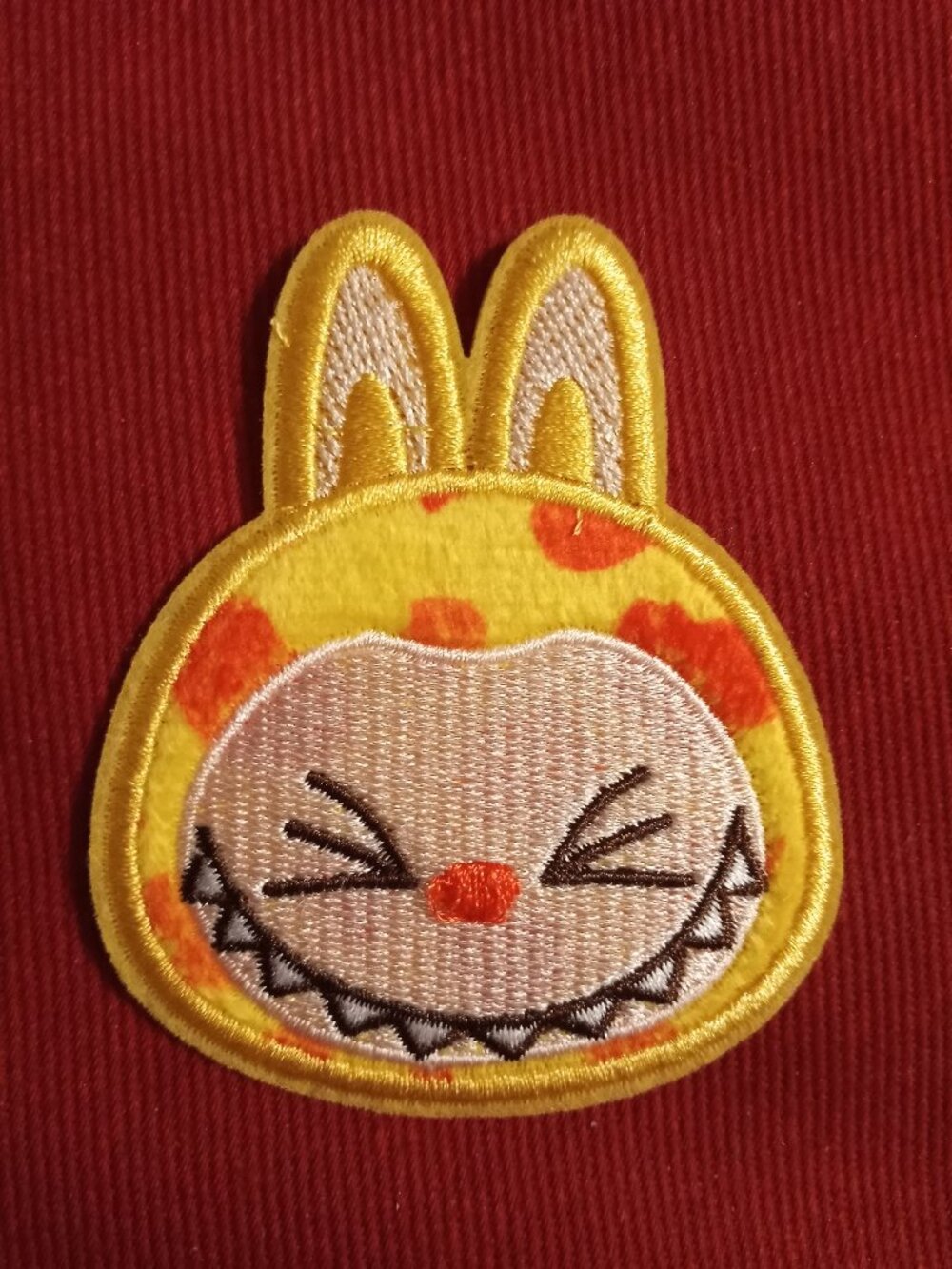 Yellow and orange squinting labubu stick on embroidered patch applique